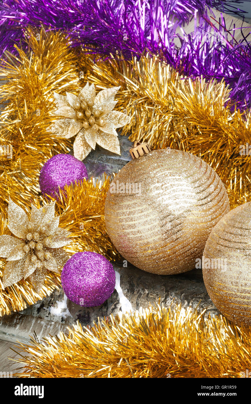 Colorful and vivid Christmas arrangement. Close Up view of Christmas golden balls with spangles and decorative tapes. Stock Photo