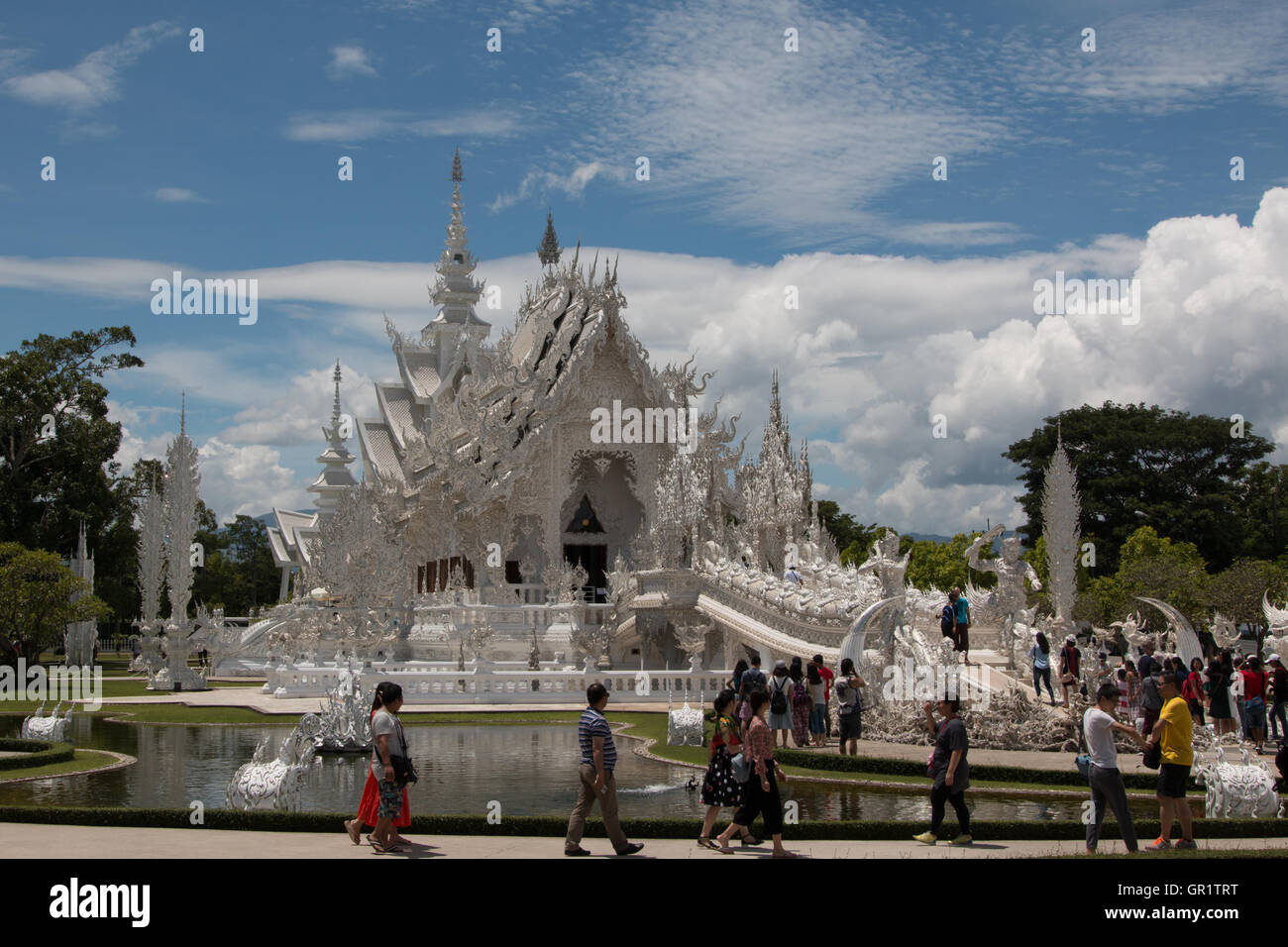 Tourists in front of White temple (Wat Rong Khun) in Chiang Rai, Thailand Stock Photo
