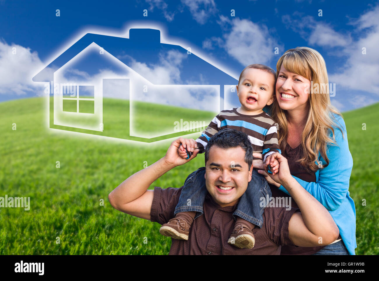 Mixed Race Family with Ghosted House Drawing and Rolling Green Hills Behind. Stock Photo