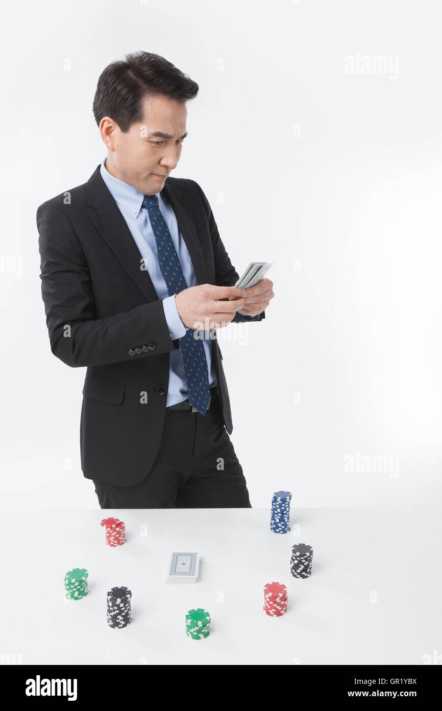 Middle aged businessman going on gamble Stock Photo