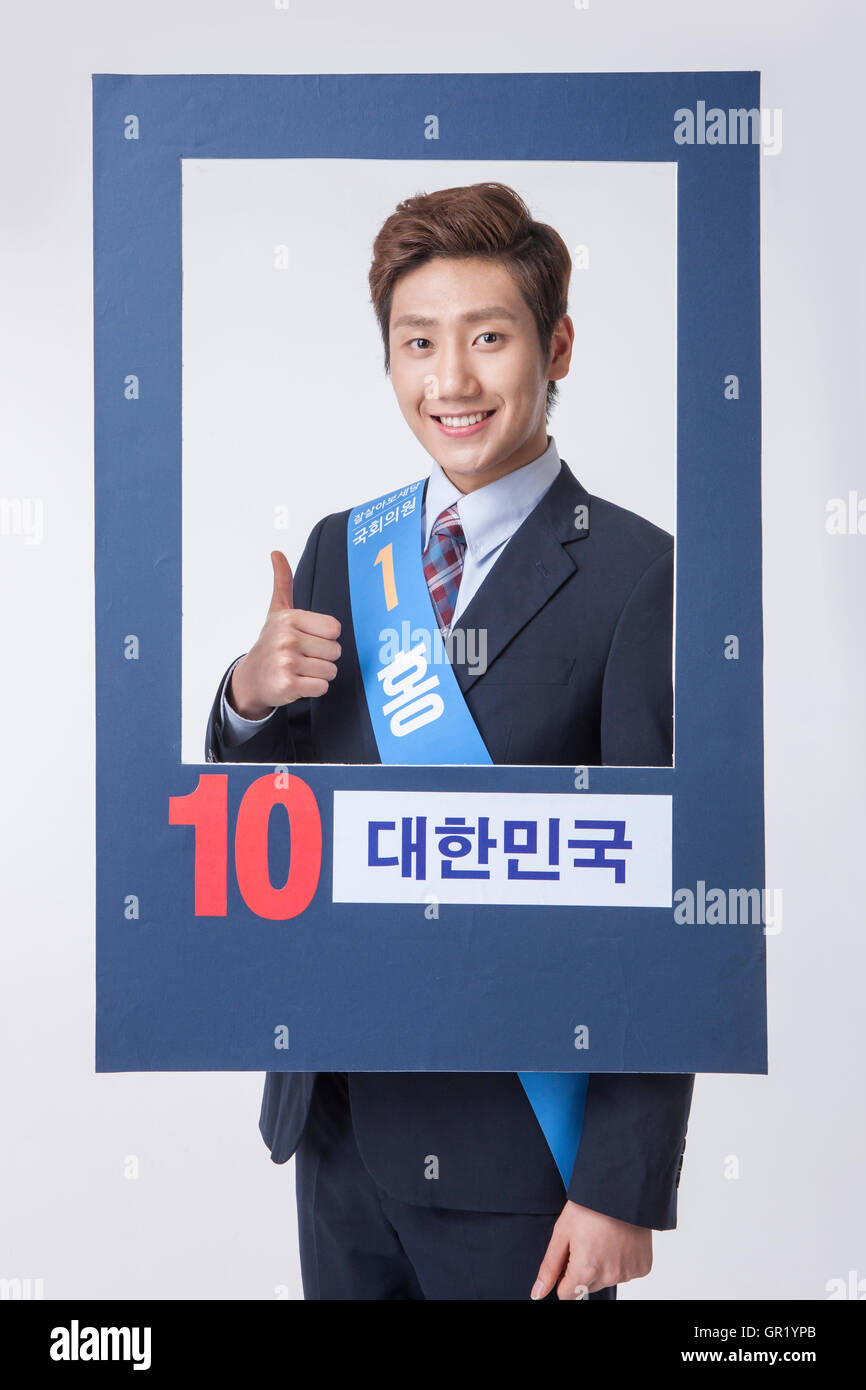 Smiling Korean candidate showing thumbup in poster Stock Photo Alamy