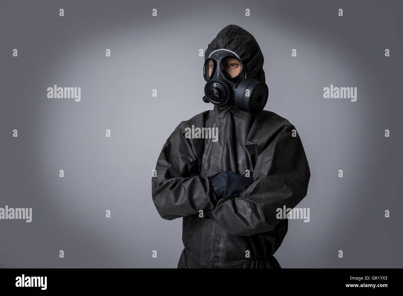 Man Using Protection Portrait of man wearing black protective clothing folding his arms ...
