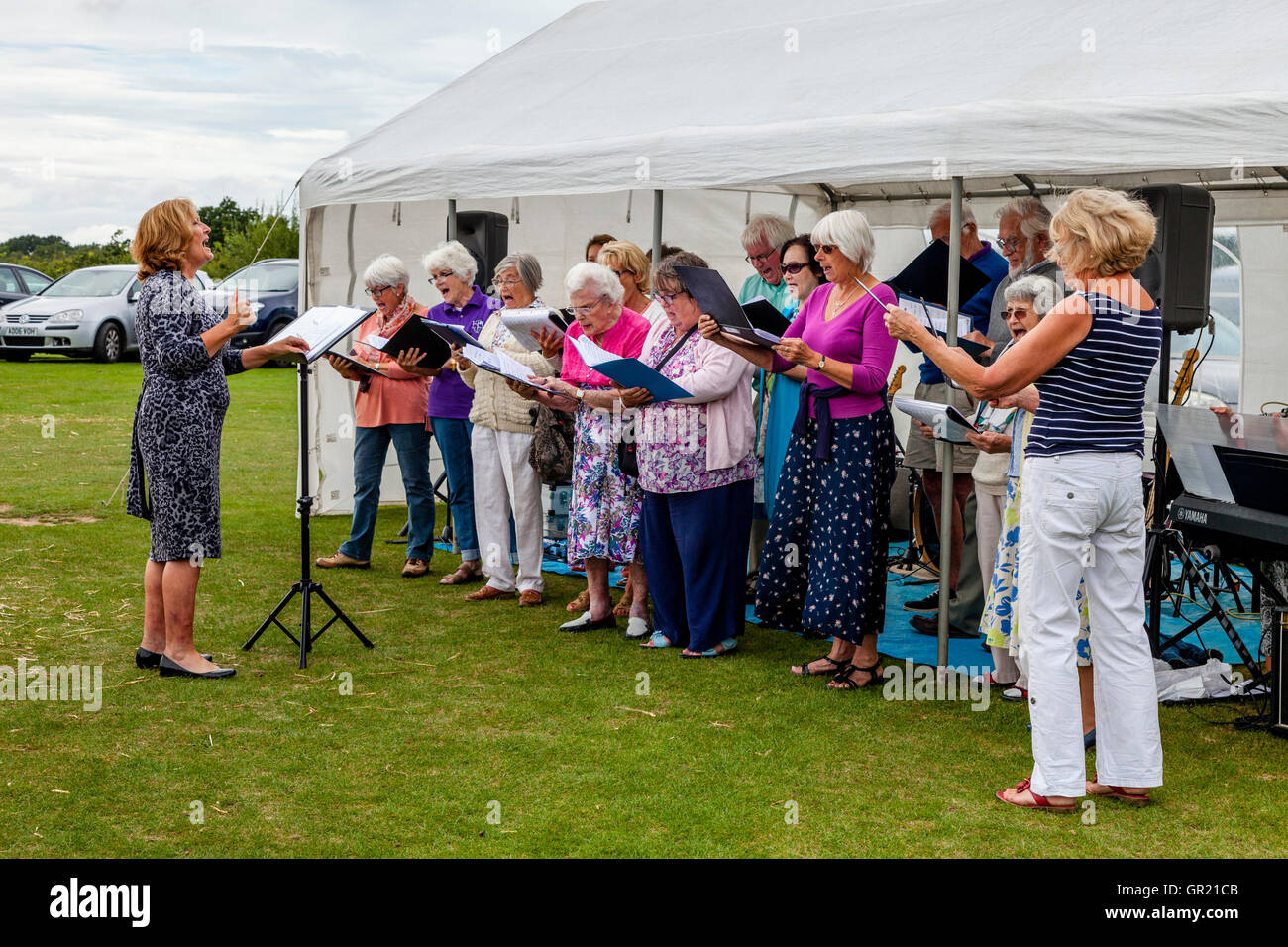 The Hartfield Singers Perform At The Annual Hartfield Village Fete, Hartfield, East Sussex, UK Stock Photo
