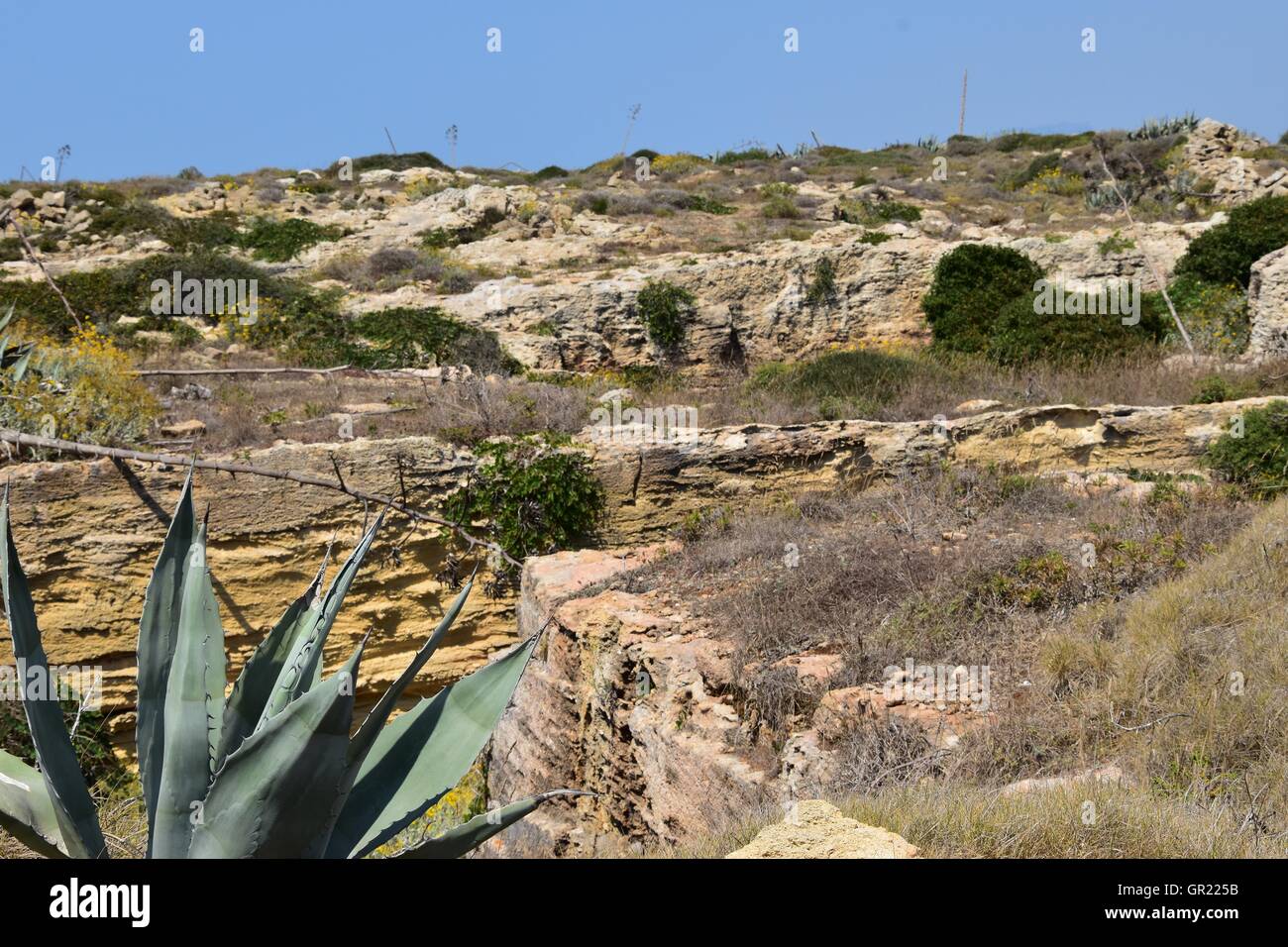 Road though desert landscape with mountains. Favignana, Sicily, Italy