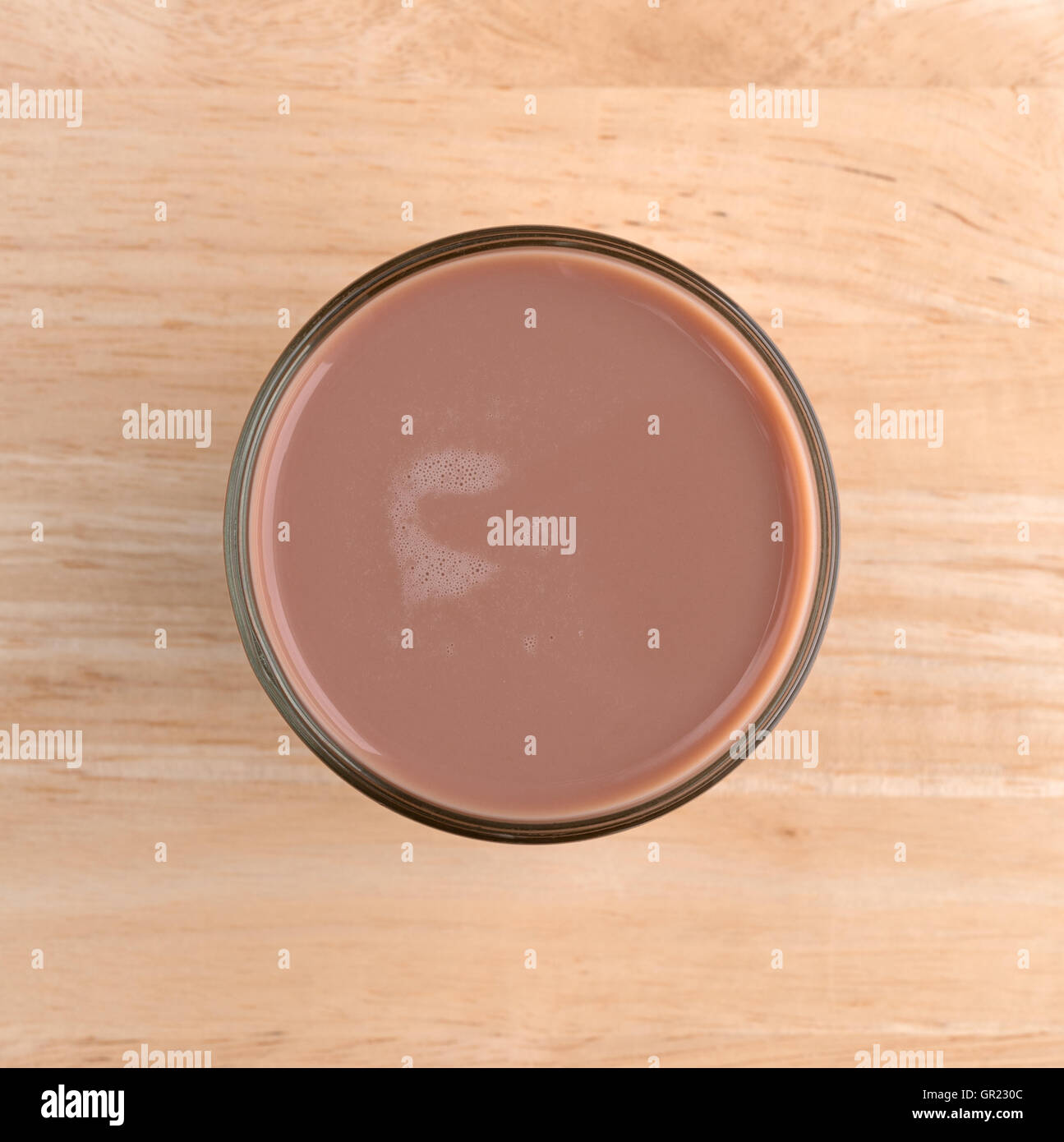 Top view of a glass of chocolate milk on a wood table. Stock Photo