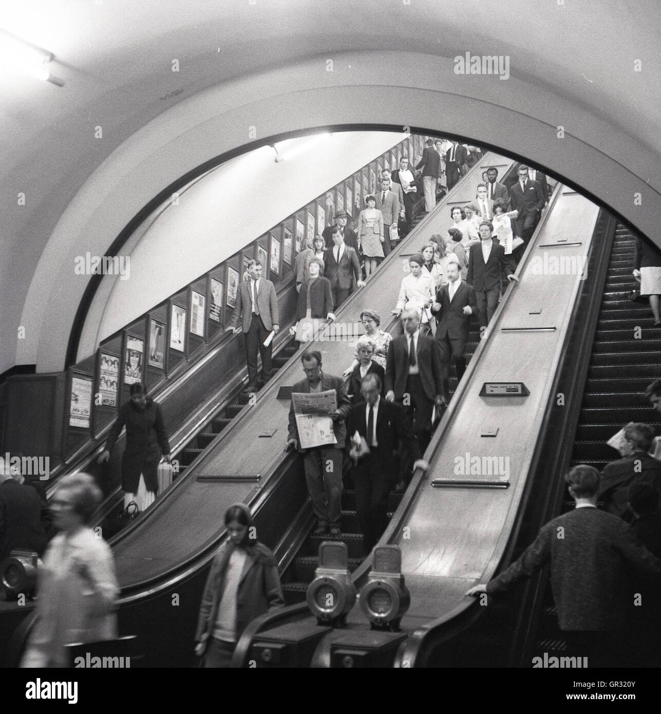 1950s, historical view of people using the wooden escalators in the