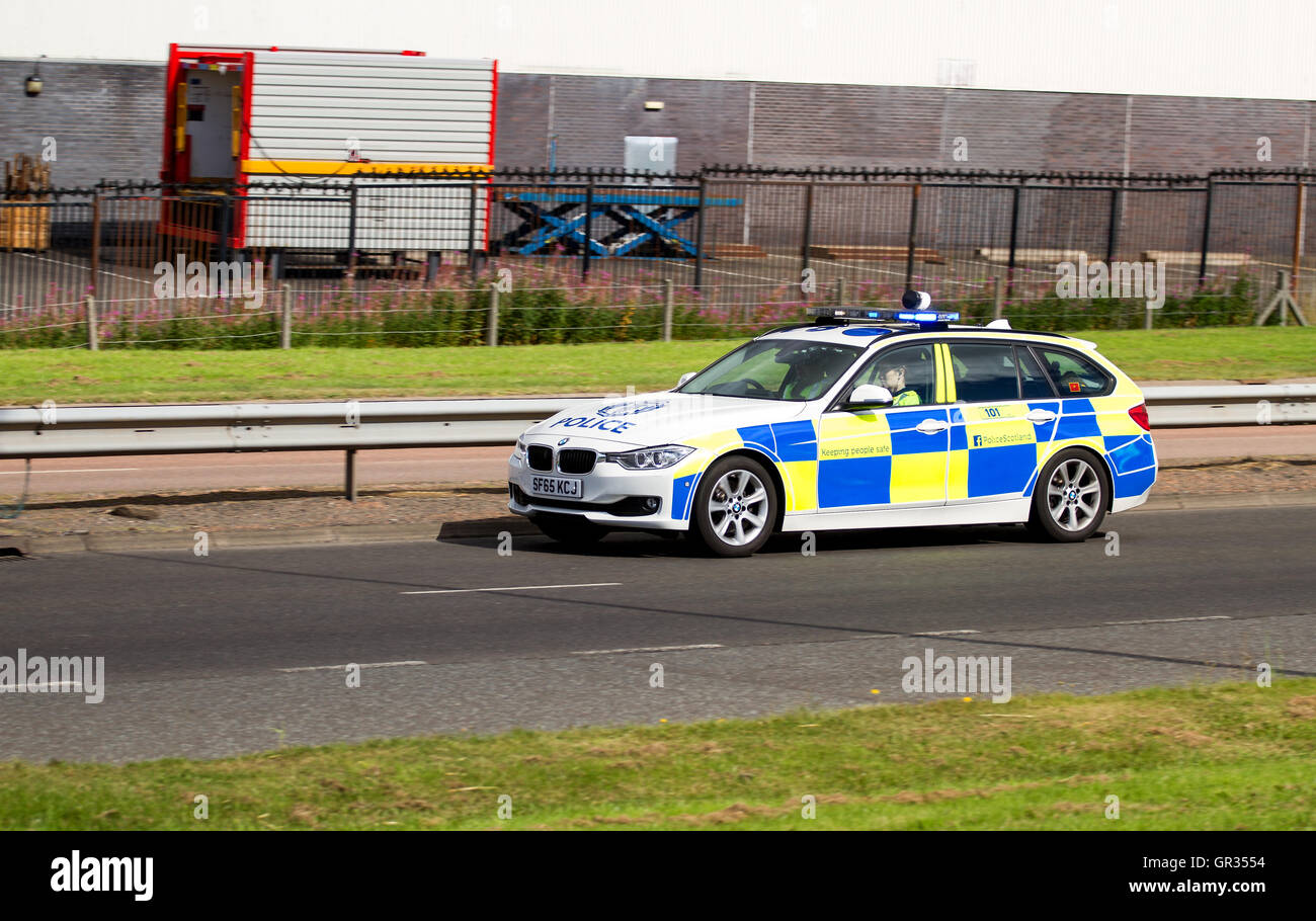 A Police Scotland BMW police car speeding in response to an incident along the Kingsway West dual carriageway in Dundee, Scotland Stock Photo