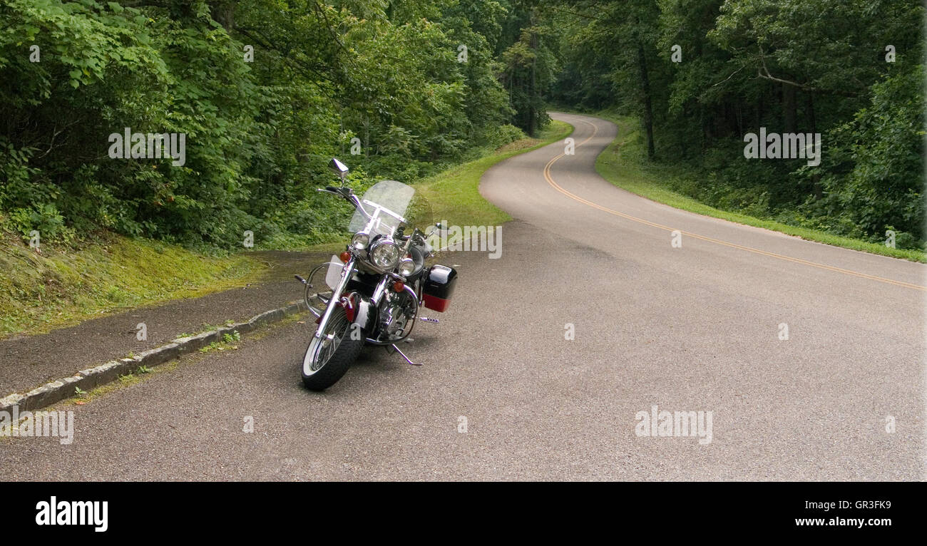 A motorcycle parked on a roadside pullout on the Blue Ridge Parkway in Virginia, USA on a summer day. Stock Photo