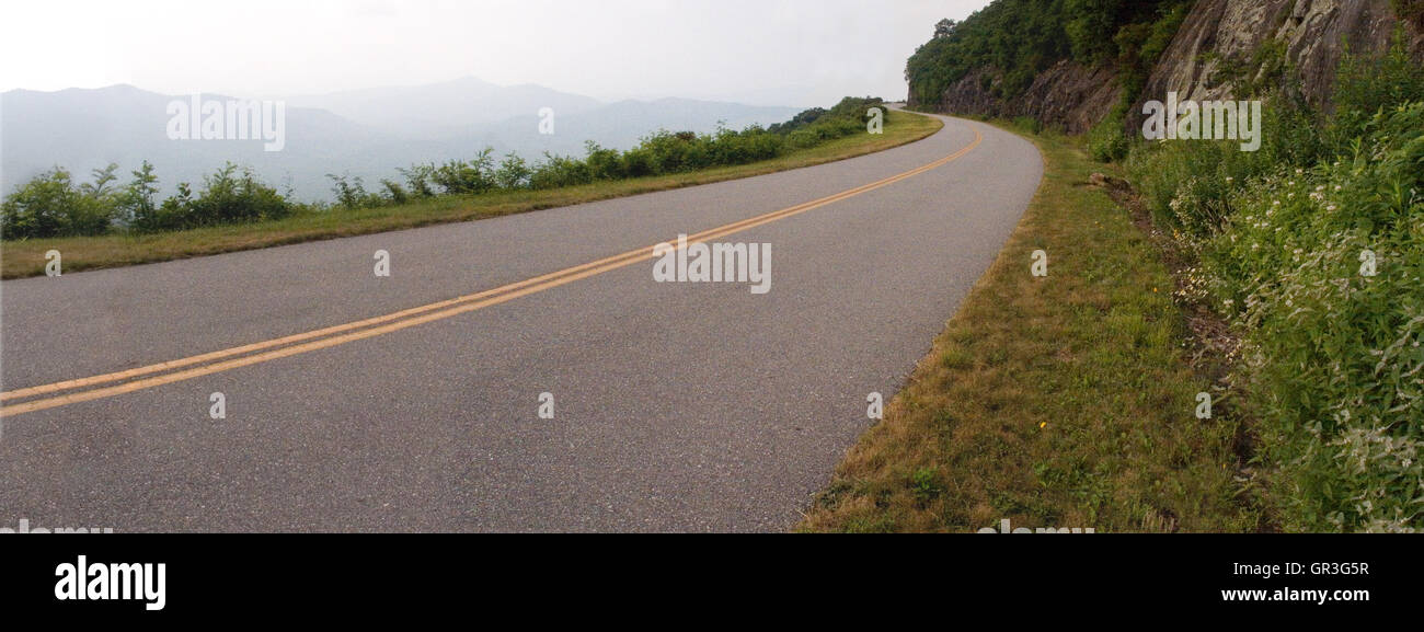 A long sweeping curve on the Blue Ridge Parkway at its upper elevations in North Carolina, USA. Stock Photo