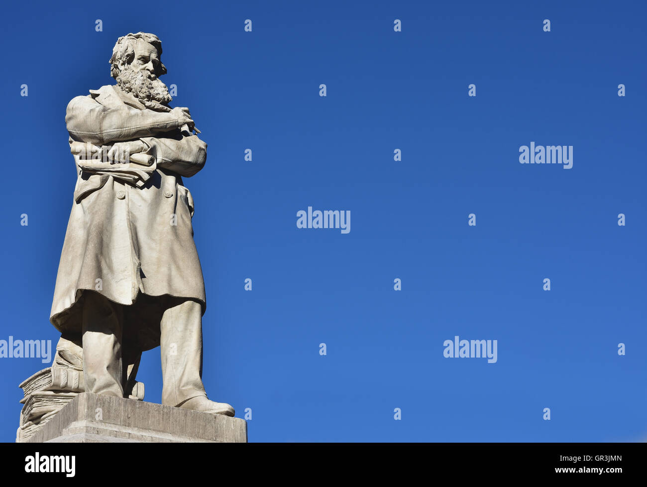 Marble statue of the Italian patriot and intellectual Niccolo Tommaseo in the center of Campo Santo Stefano square (19th century Stock Photo
