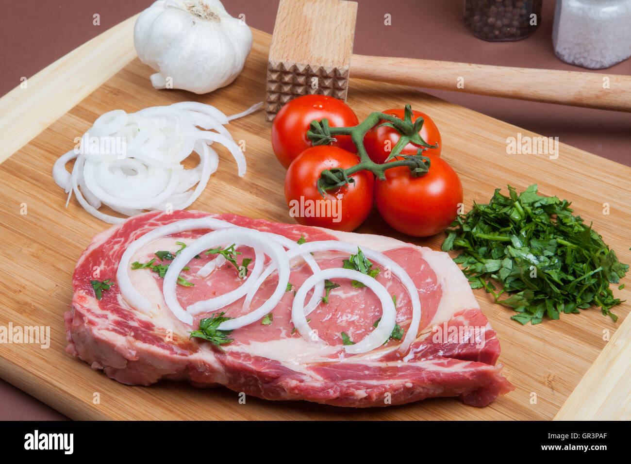Rib Eye Steak,  chopping board,  meat, protein, beef, dinner,steak, marble, thick, isolated, onions, tomatoes on a vine, Stock Photo