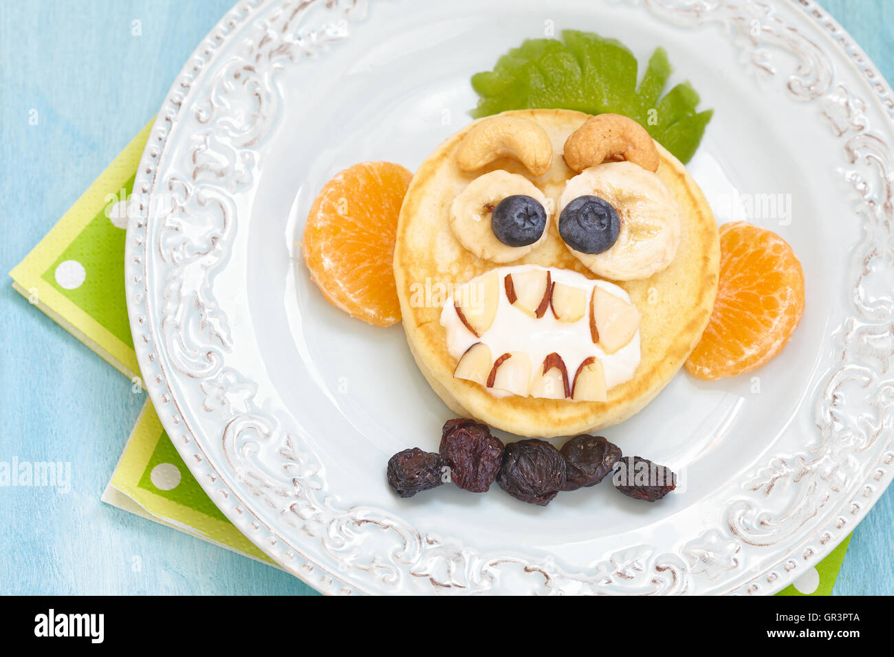 Funny Halloween pancake with scary monkey face Stock Photo