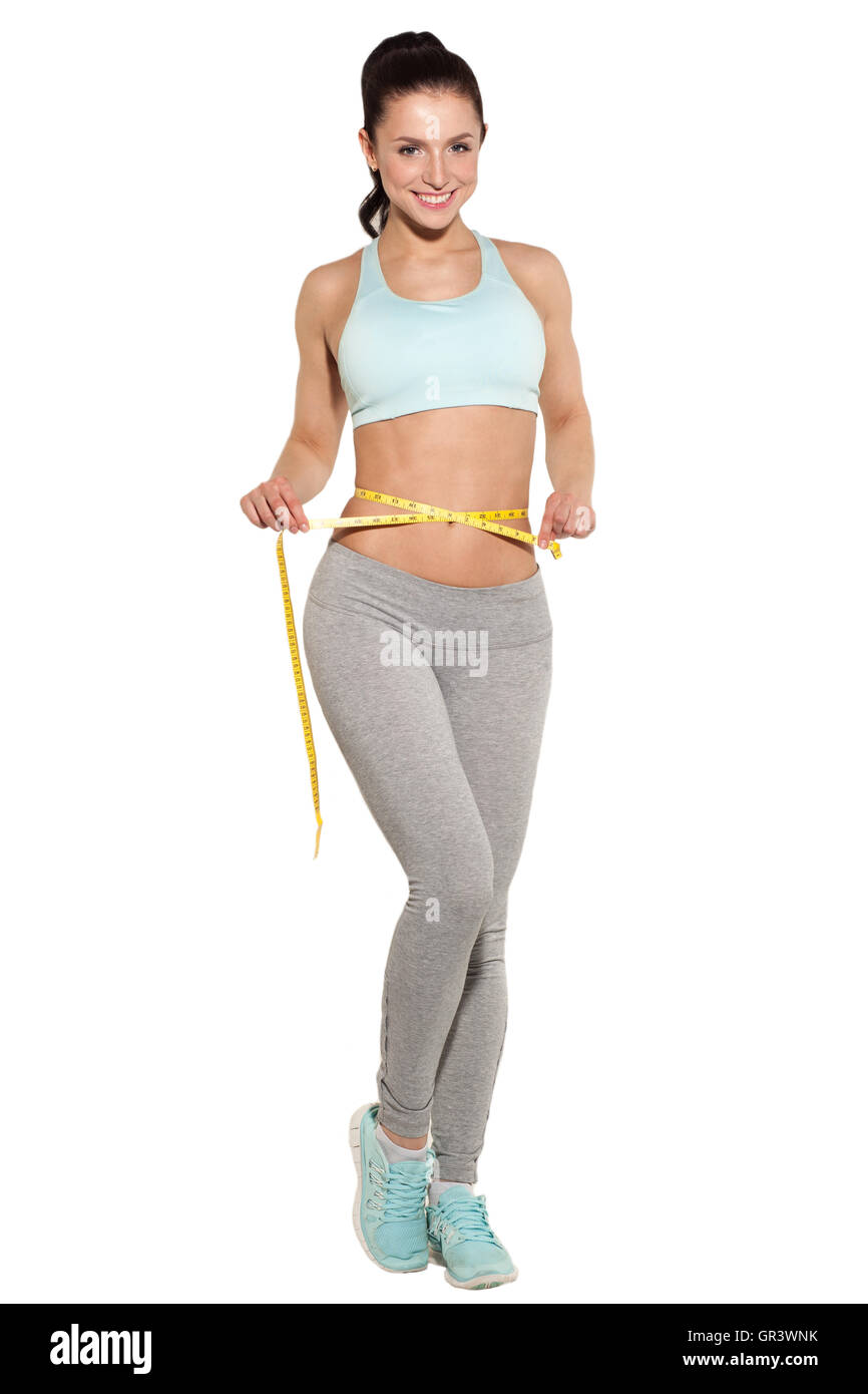 weight loss, sports girl measuring her waist, training in the gym, workout abdominals Stock Photo