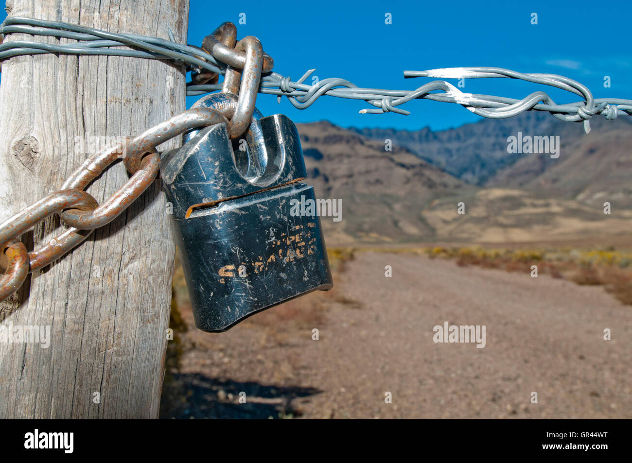 Locked gate blocking access to public land; Steens Mountain, Oregon Stock Photo