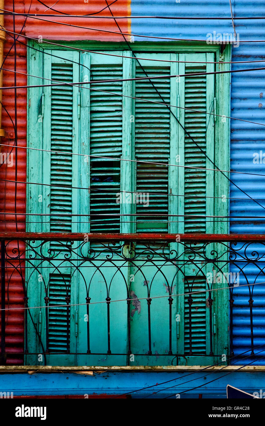 green wood blind and a red blue wall Stock Photo Alamy