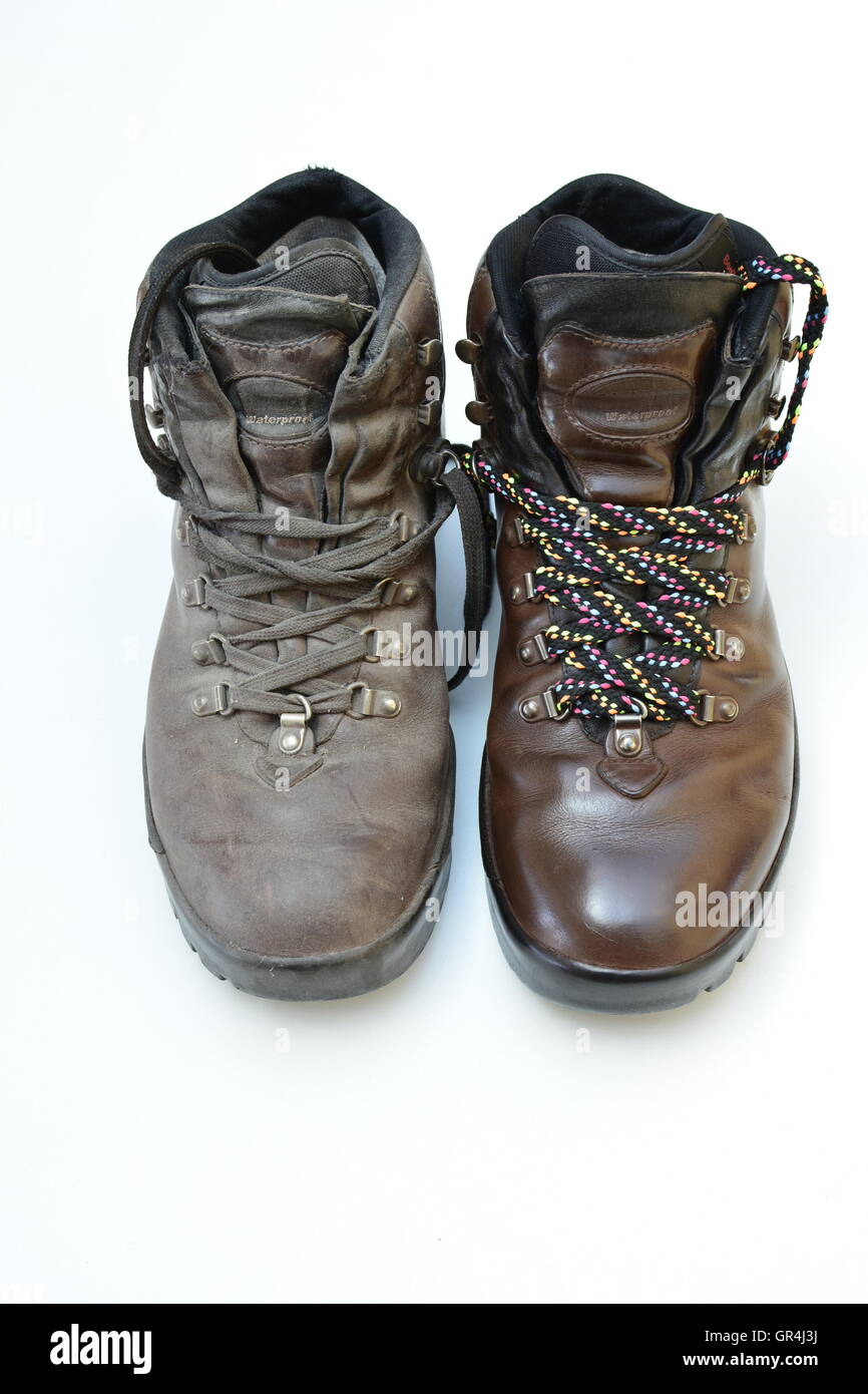 Makeover theme and concept. Old dirty boot vs polished and made over boot with new colorful laces. old vs new. dirty vs clean. Stock Photo