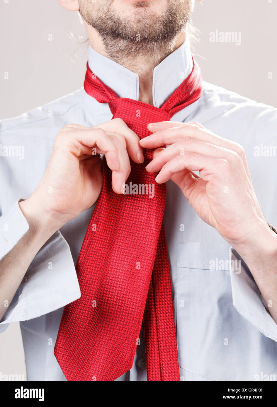 Man adjusting tie Stock Photo - Alamy