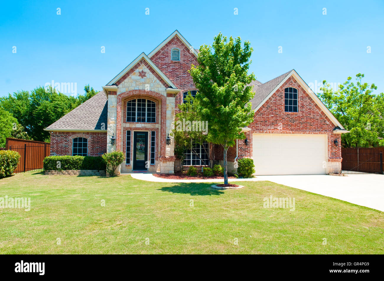 Two Story Brick Home With The Garage In The Front Stock Photo