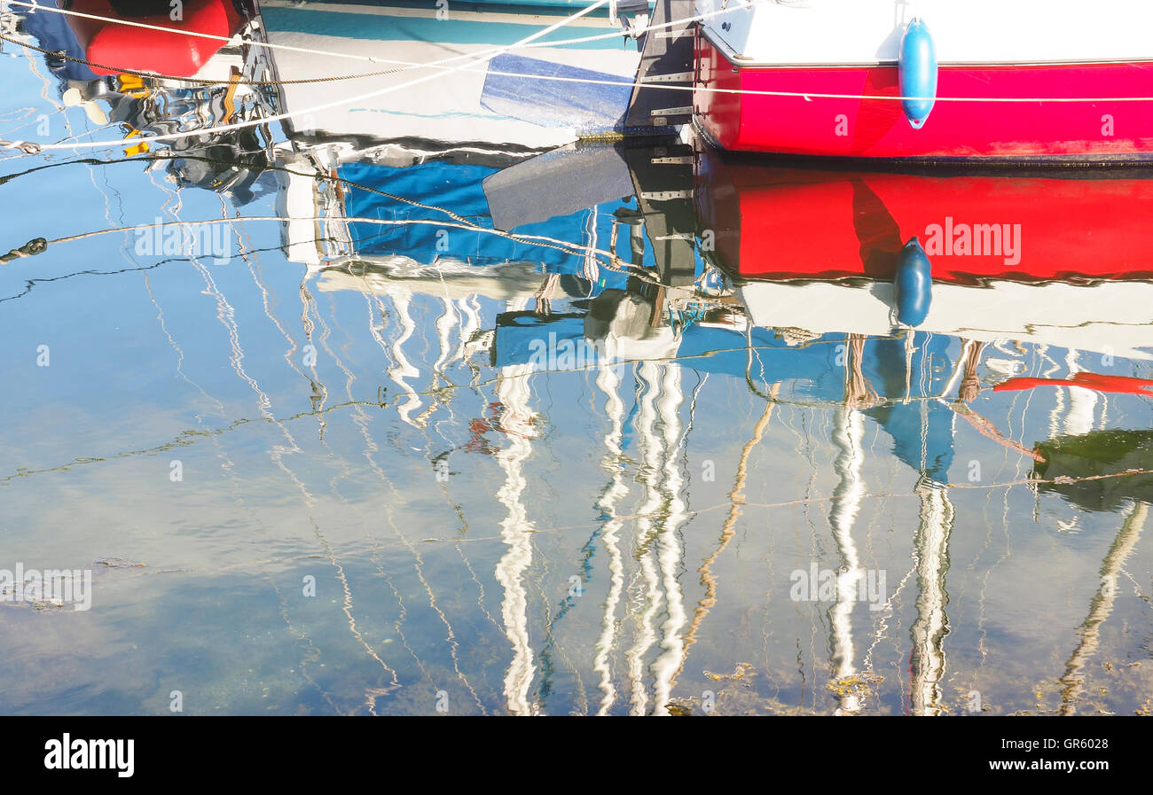 Reflections of colorful boats in a marina Stock Photo - Alamy