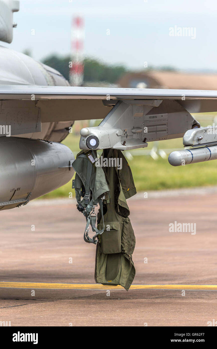 Pilots Anit G Suit hanging from the weapons pylon on an F-16. Stock Photo