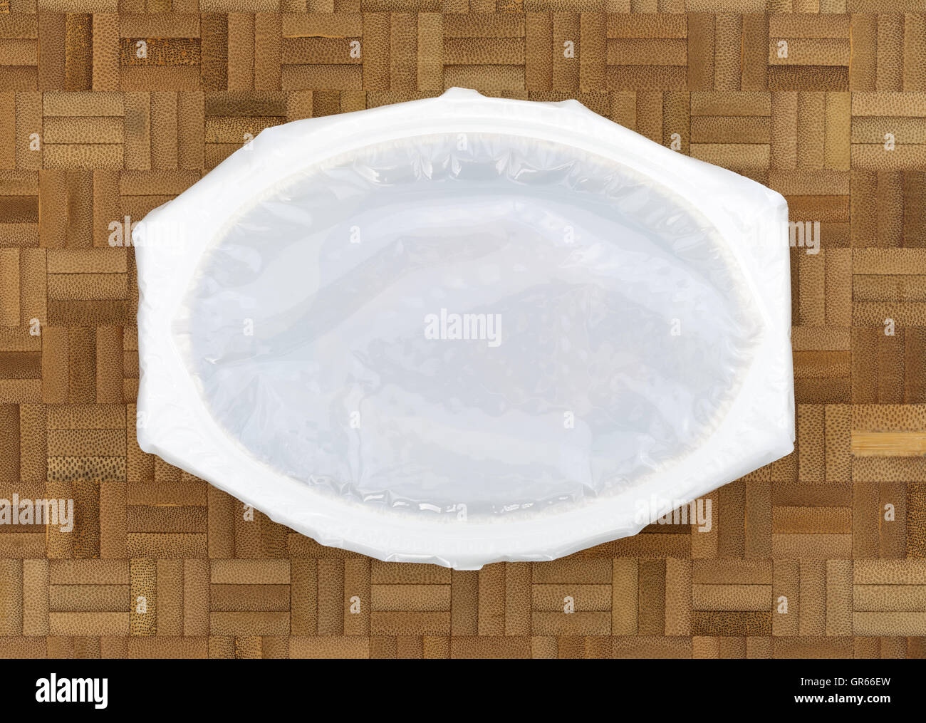 Top view of an unopened TV dinner on a wood block cutting board. Stock Photo