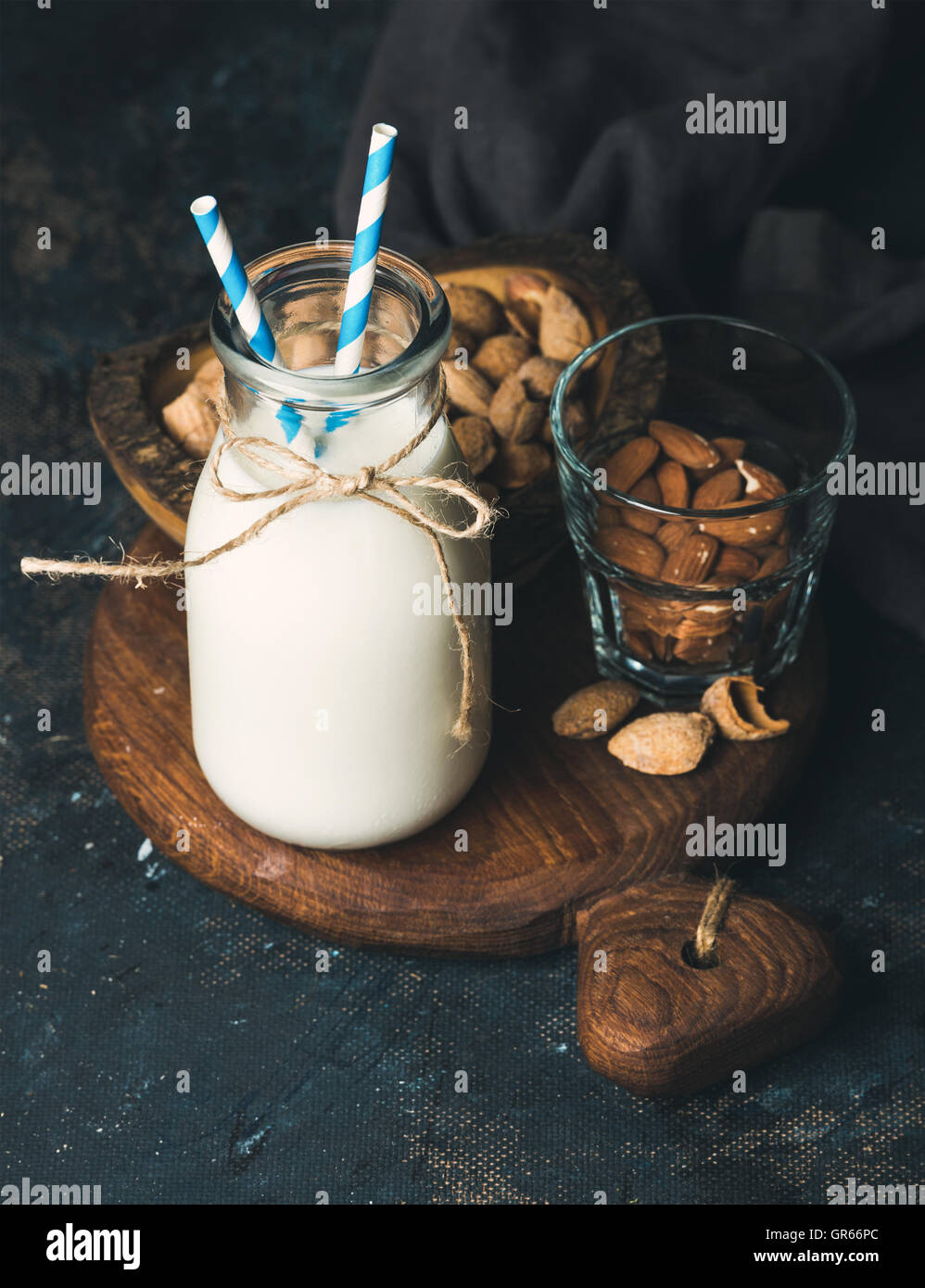 Fresh almond milk in glass bottle served with almonds Stock Photo - Alamy