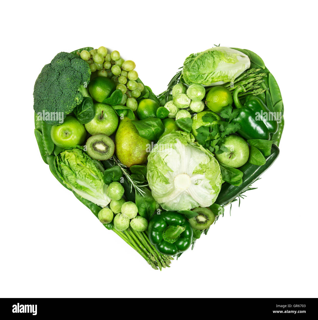 Heart of green fruits and vegetables isolated on a white background Stock Photo