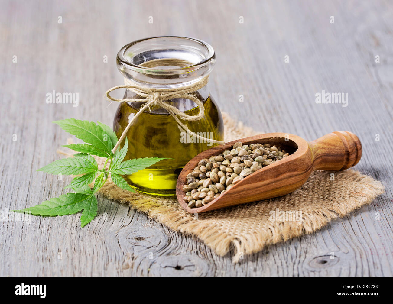 Hemp oil n a glass jar and hemp seeds Stock Photo