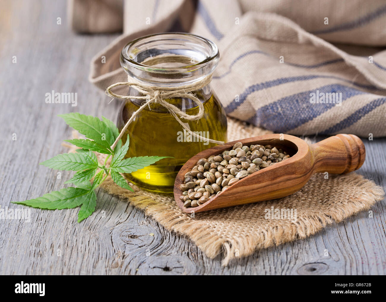 Hemp oil n a glass jar and hemp seeds Stock Photo