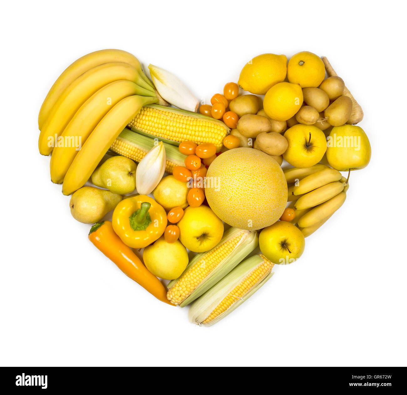 Heart of yellow fruits and vegetables isolated on a white background Stock Photo
