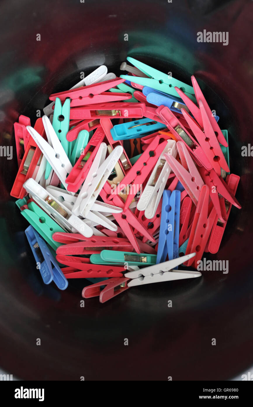 Mixed colour clothes pegs against black Stock Photo Alamy