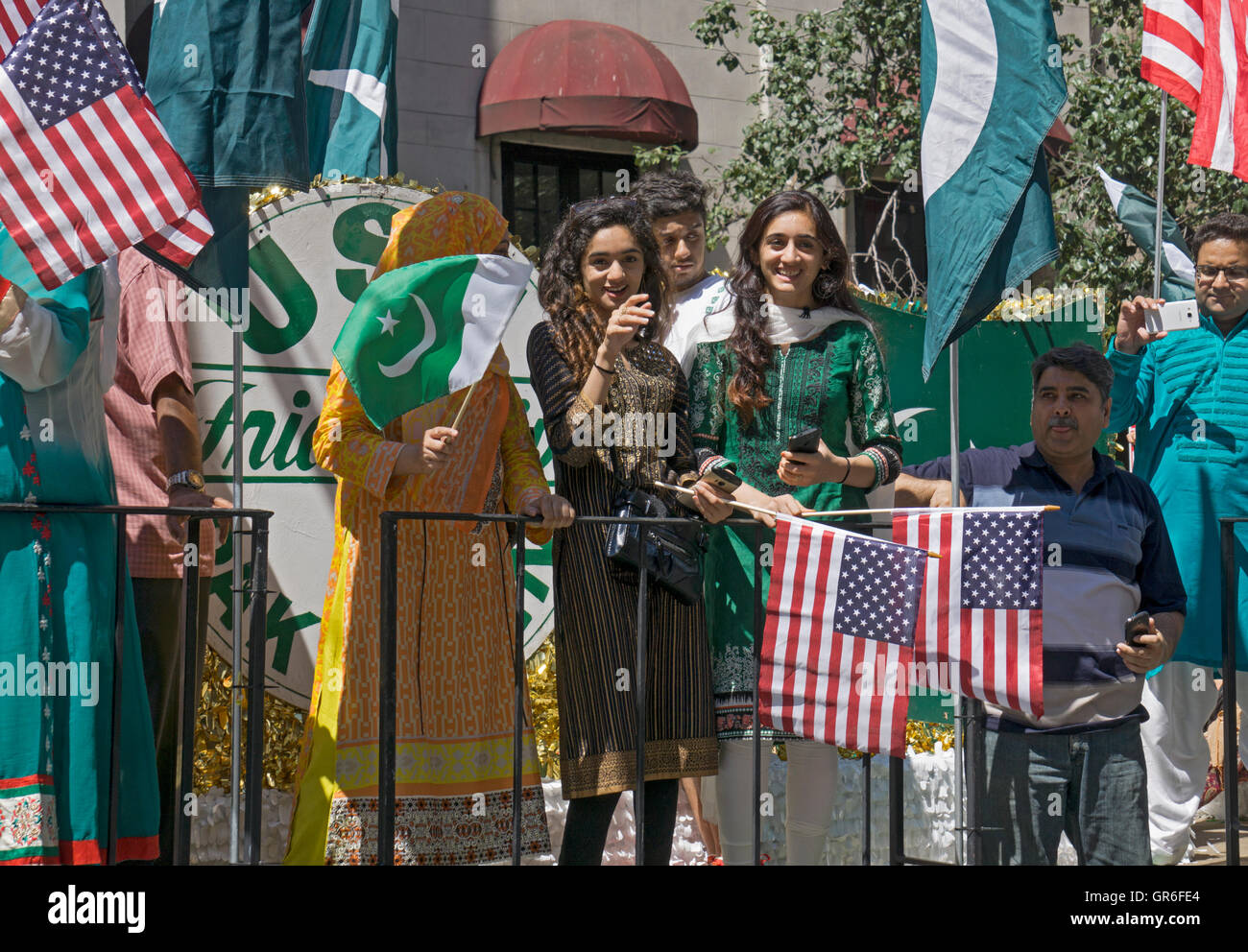 Young Pakistani girls on a float waving American flags at the 2016 Pakistan Day Parade in Manhattan, New York City Stock Photo