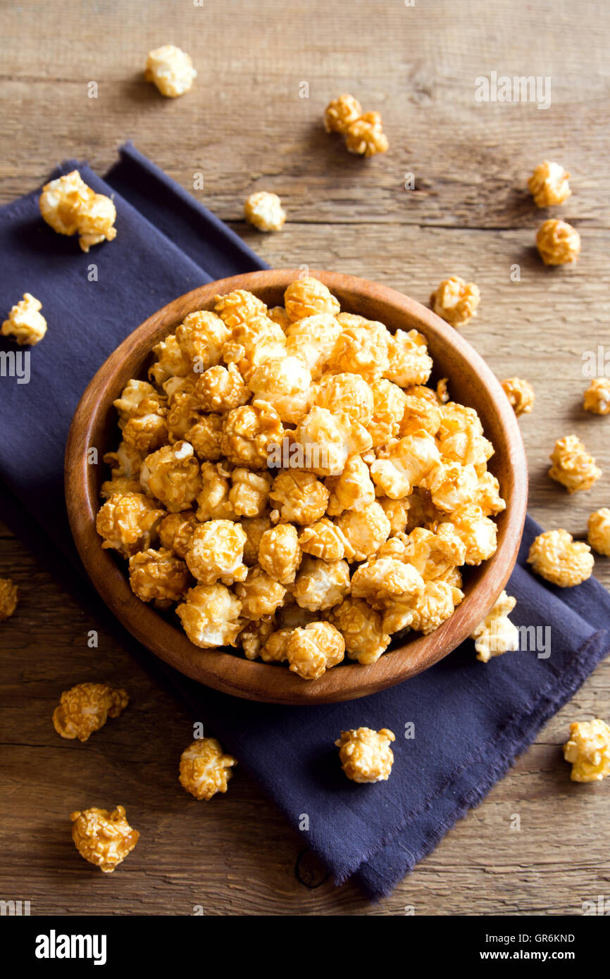 Homemade caramel popcorn in wooden bowl Stock Photo