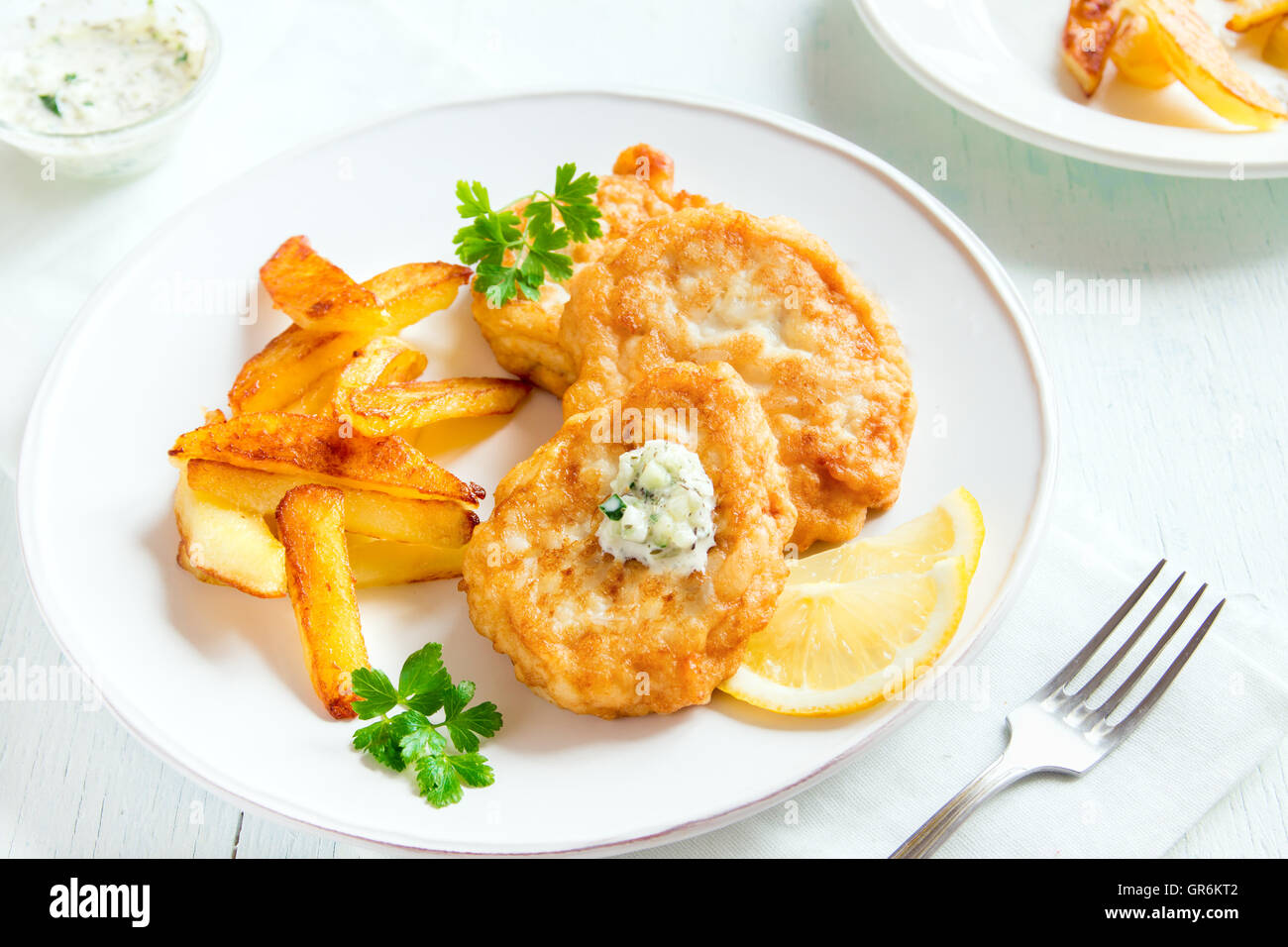 Homemade fish cakes with french fries on white plate close up Stock ...