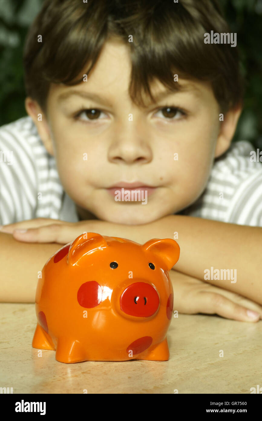 Boy With A Piggy Bank Stock Photo - Alamy