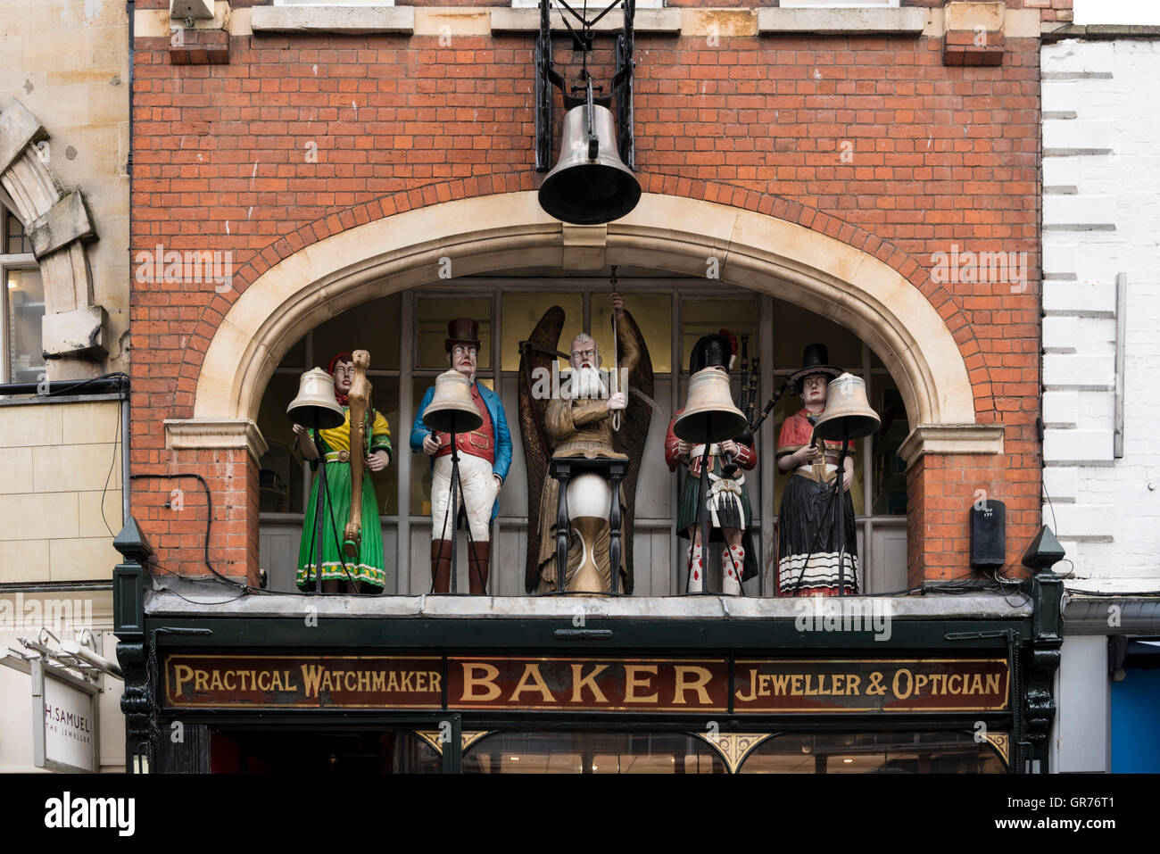 Chiming clock with figures in Baker's Jewelery and Watchmaker shop, Gloucester, Gloucestershire, UK Stock Photo