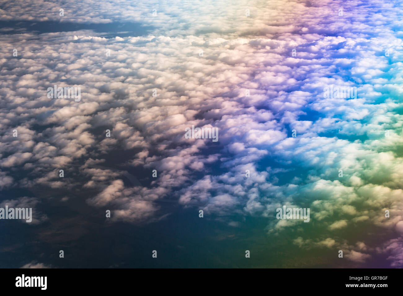 Airplane flying above cumulus clouds. View of sky from aircraft, long distance travel by airtransport. Russian airlines Stock Photo