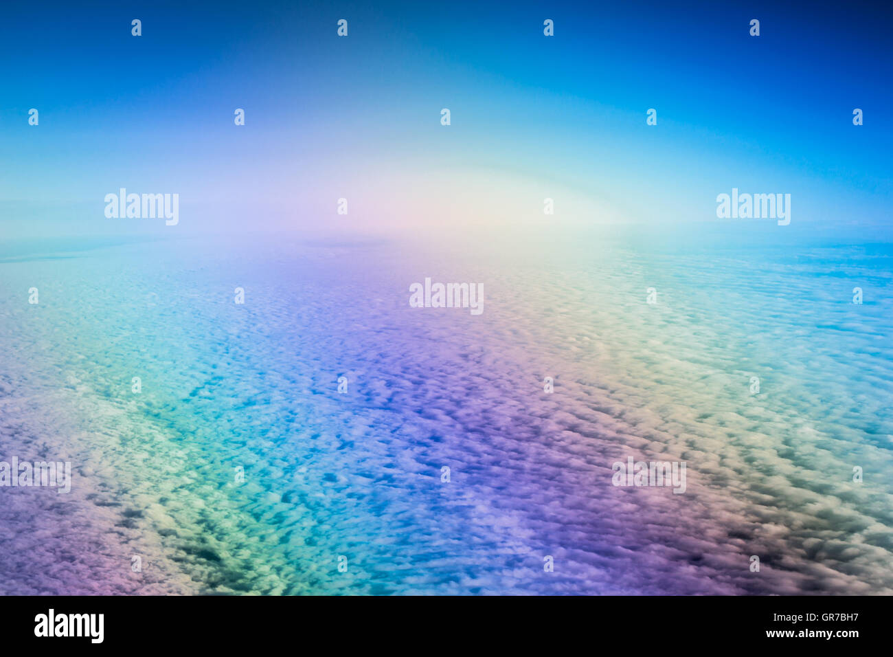 Airplane flying above cumulus clouds. View of sky from aircraft, long distance travel by airtransport. Russian airlines Stock Photo