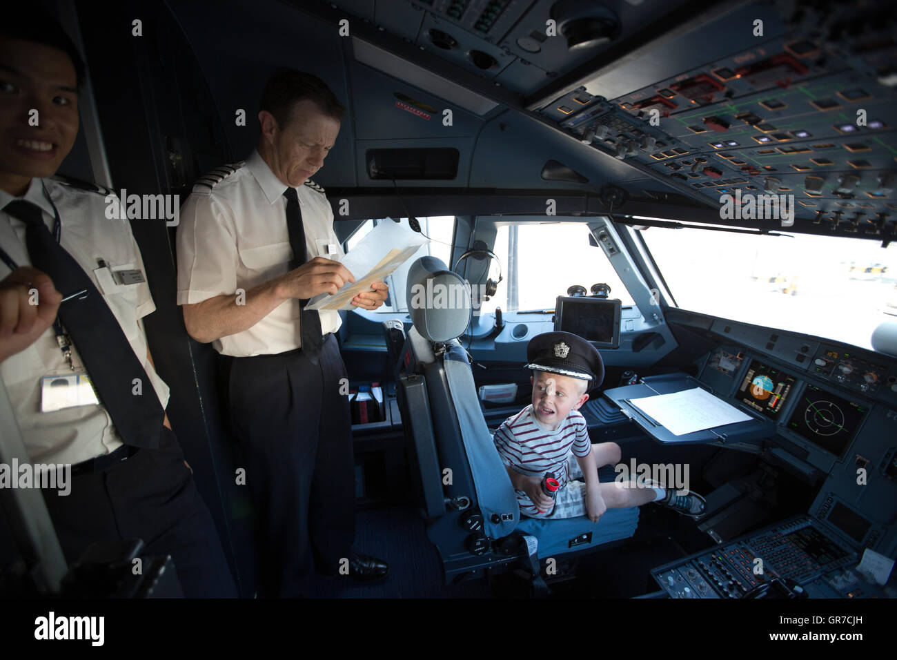 Young boys aged 5 and 2 visiting British Airways cockpit, whilst the ...