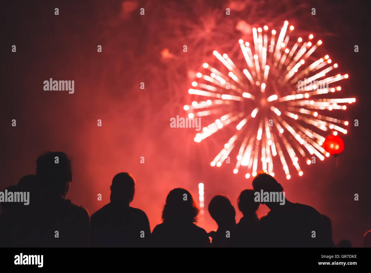 Happy people watching fireworks Stock Photo - Alamy