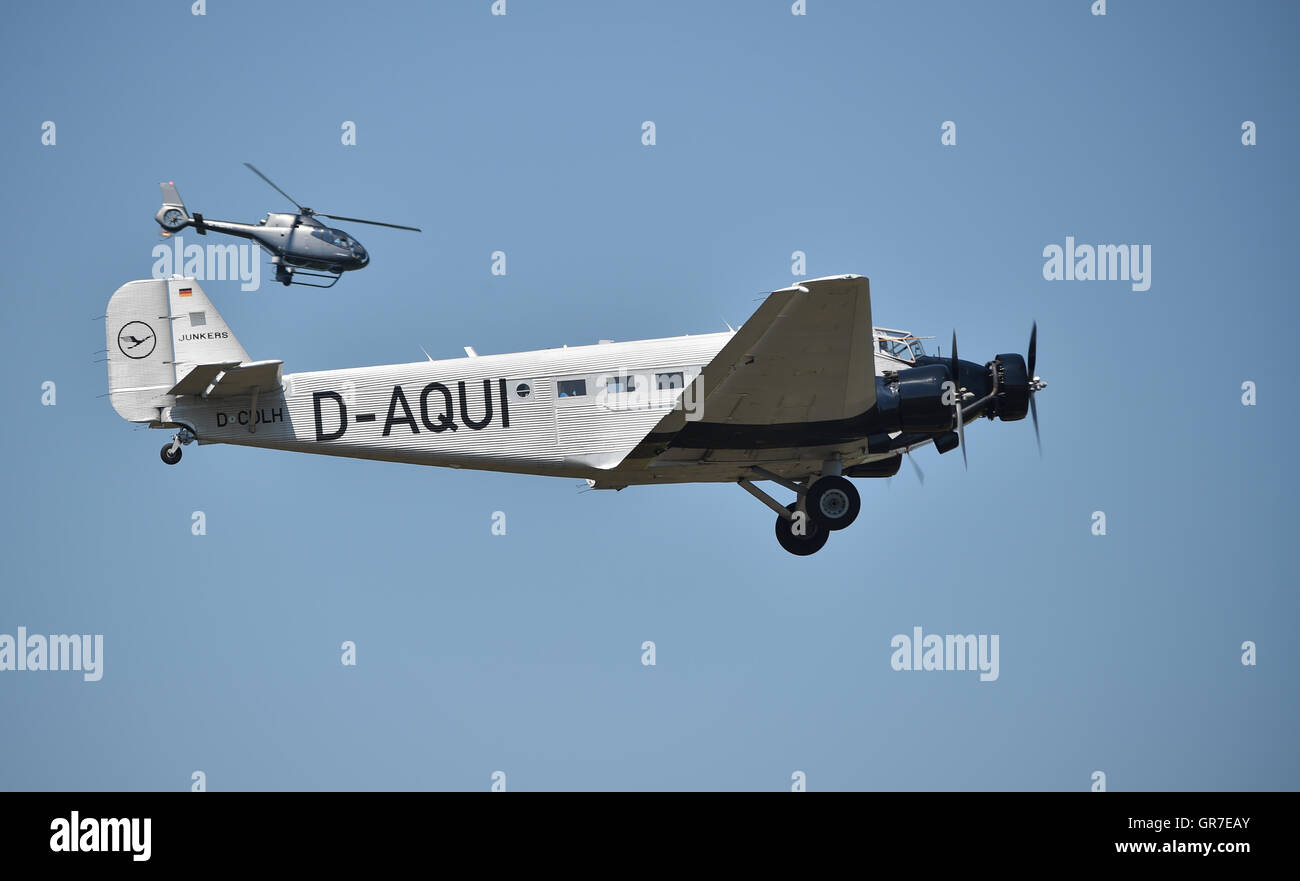 Propeller plane Ju 52 and helicopter flying over Hesse, Germany
