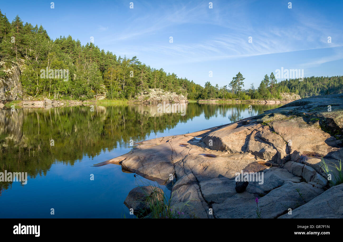 Green forest and stone shores at Karelia islands. Stock Photo