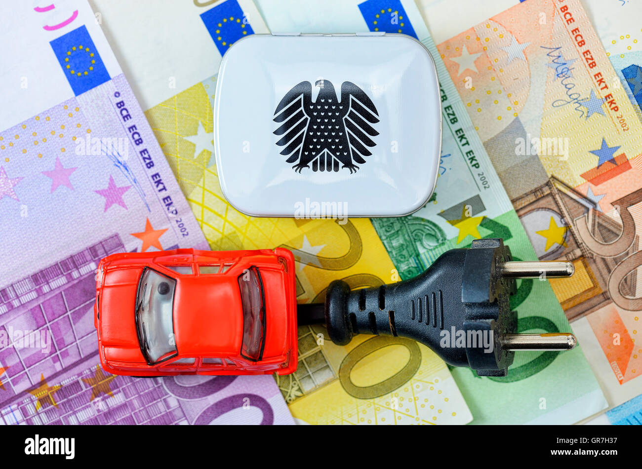 Toy Car, Plug And German Federal Eagle On Euro Banknotes, Electric Car Bonus Stock Photo
