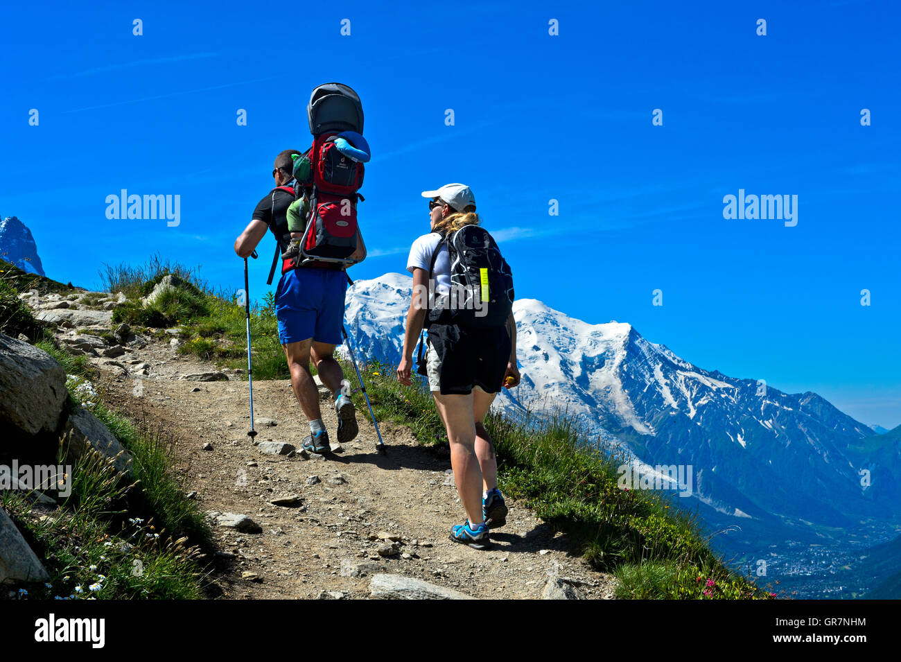 Couple With Toddler In A Child Carrier Backpack On A Hiking Tour, Mont Blanc Massif Behind, Chamonix, France Stock Photo