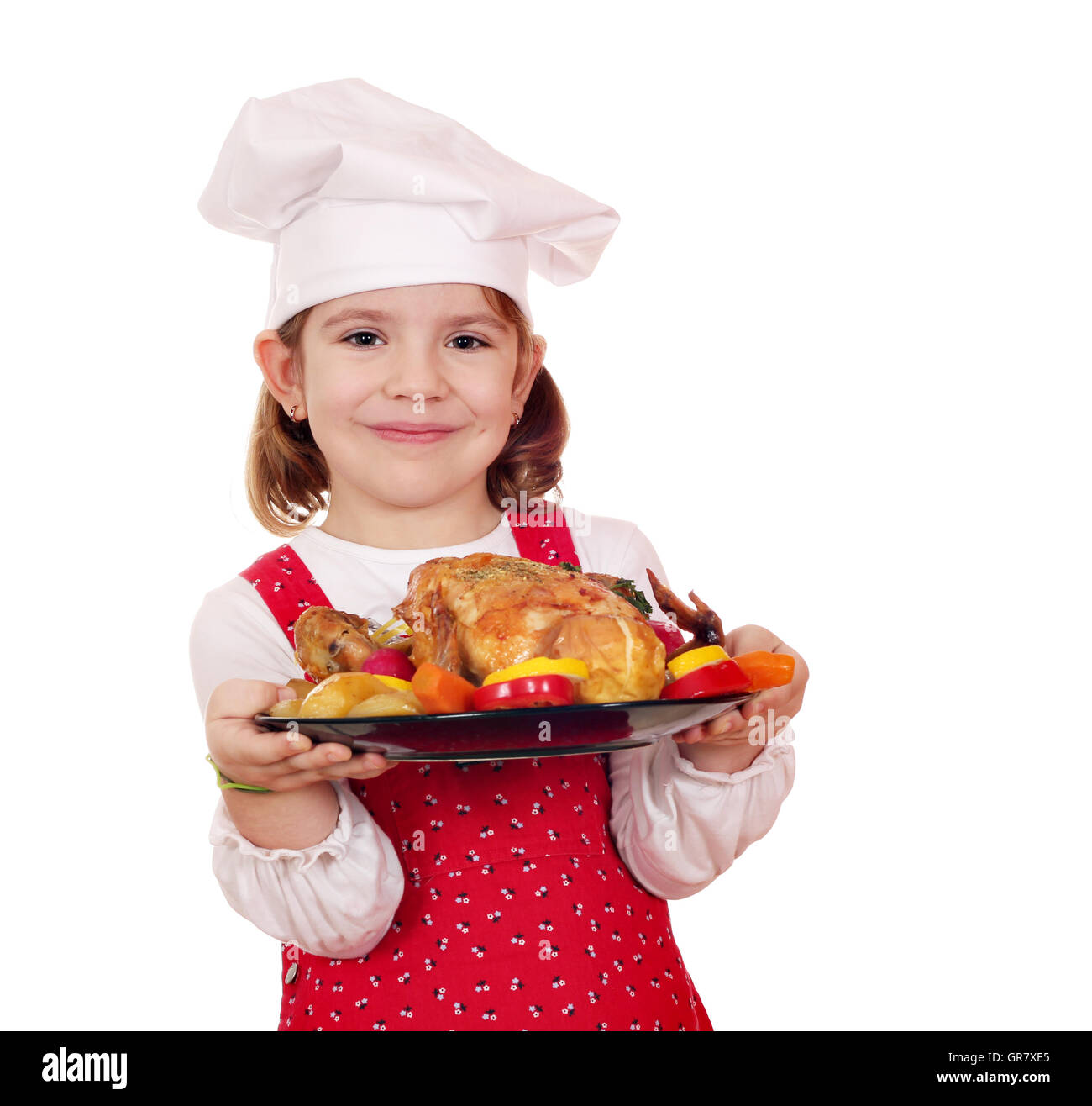 little girl cook holding roasted chicken Stock Photo