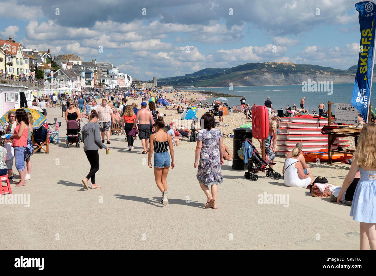 People stroll along the beach waterfront at Lyme Regis, Dorset, England UK  KATHY DEWITT Stock Photo