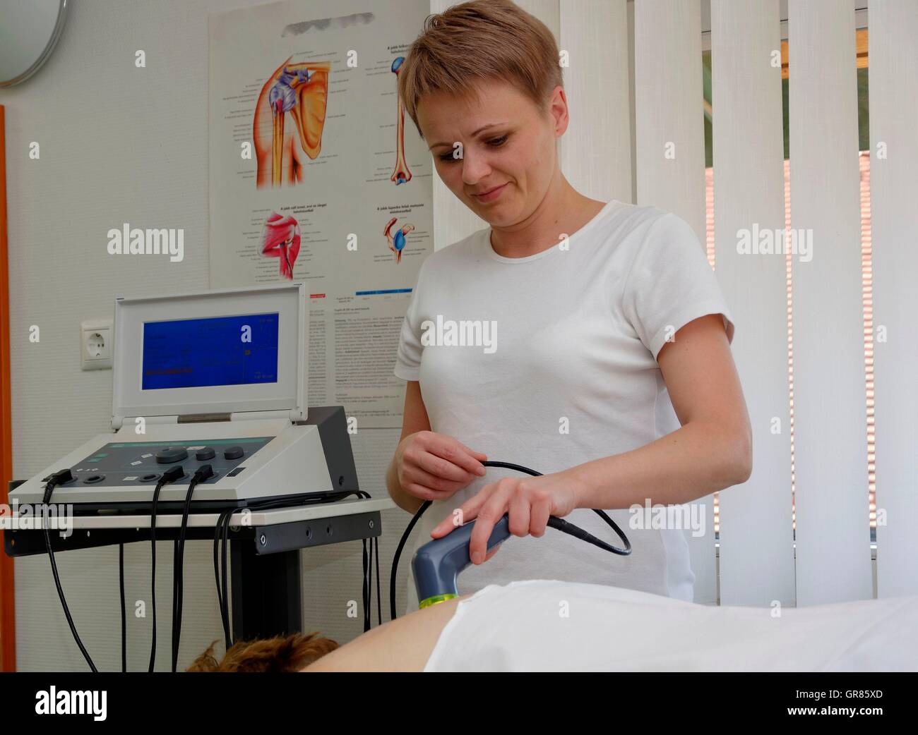 Electric Physiotherapy Application By Therapist On The Back Of A Woman In Spa Cegled Stock Photo