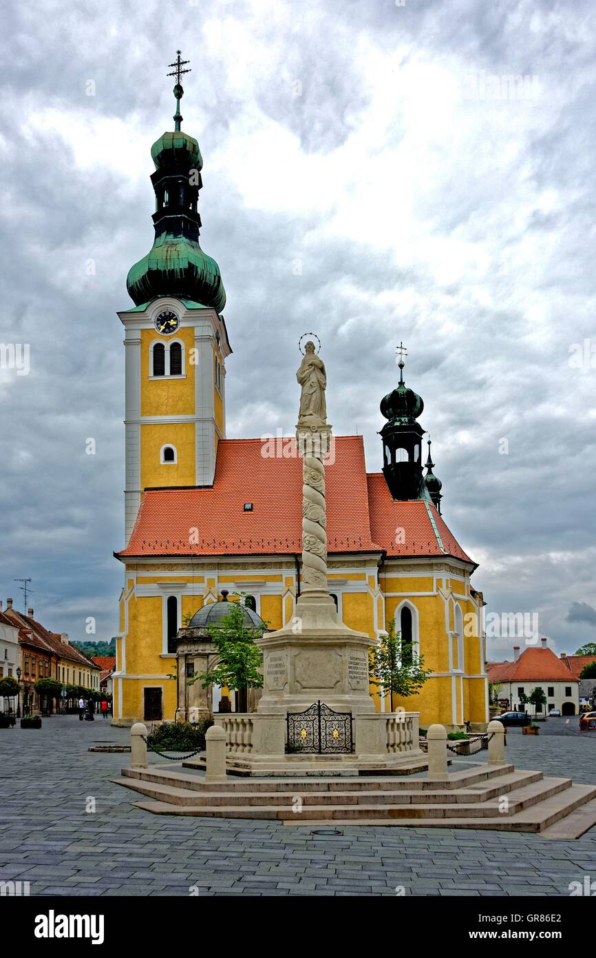 St. Imre Church With Holy Trinity Column On Jurisics Place In Koszeg, Hungary Stock Photo