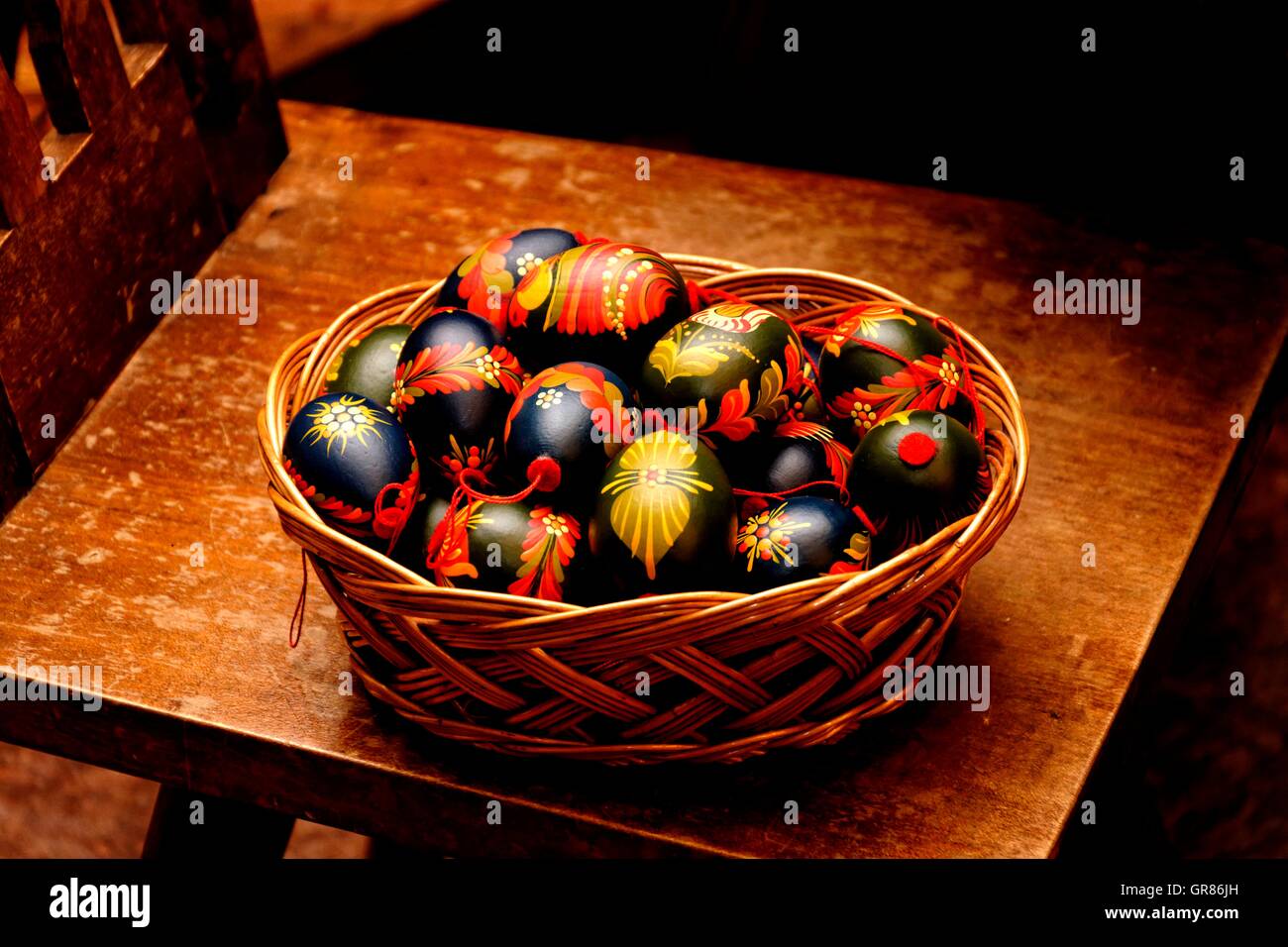 Brightly Painted, Yellow, Red, Black Easter Eggs In Basket Stock Photo