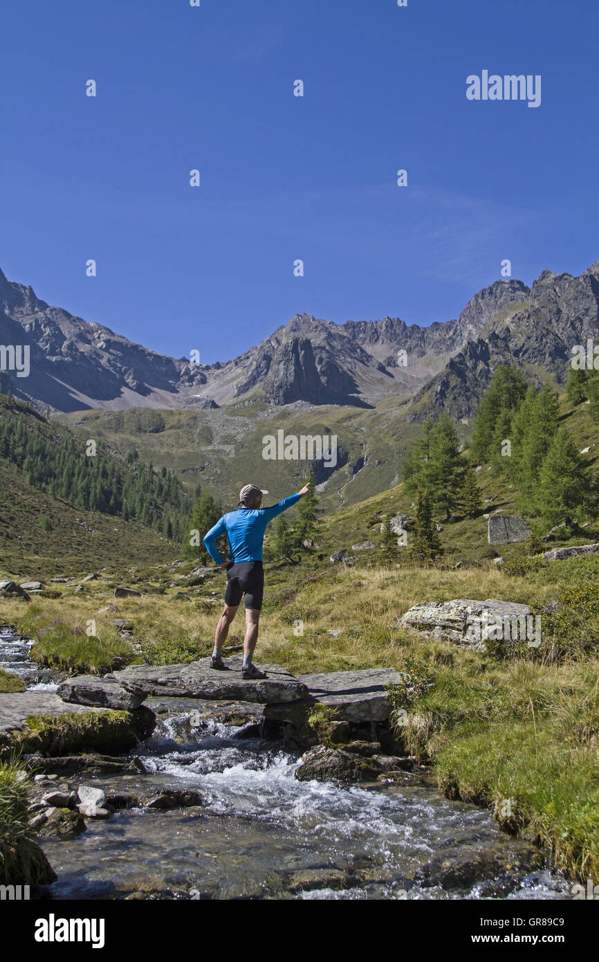 Hikers On A Small Bridge In The Ötztal Valley Stock Photo